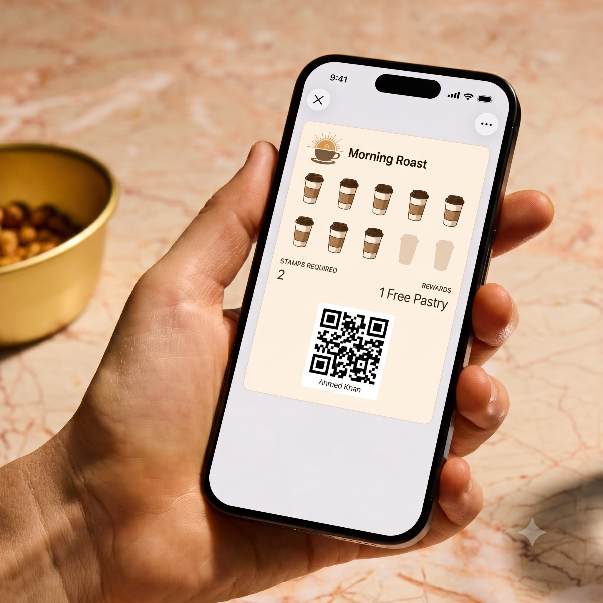 A customer holding a phone displaying a Morning Roast digital loyalty card